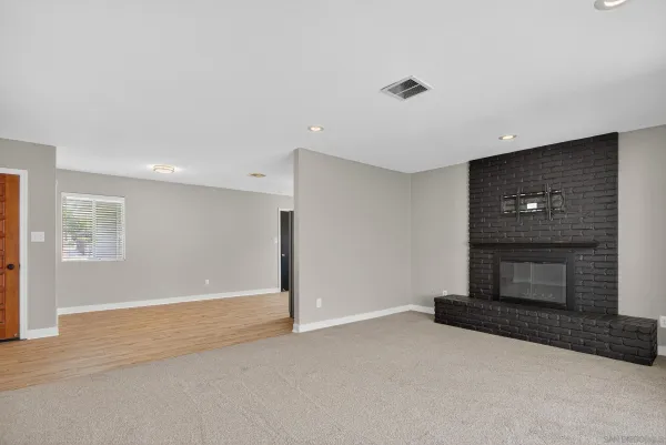 a view of an empty room with a fireplace