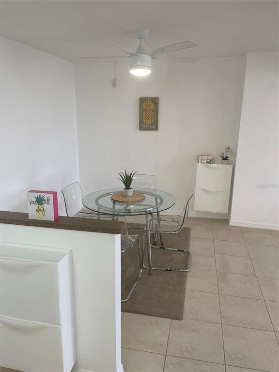 1 Key Capri, Unit 104W Treasure Island, FL 33706 - Photo 11 of 49 a room with a table and chairs