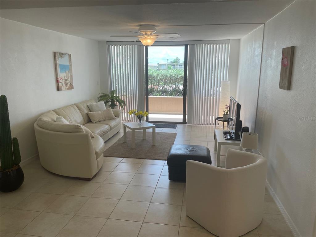 1 Key Capri, Unit 104W Treasure Island, FL 33706 - Photo 13 of 49 a living room with furniture and a large window