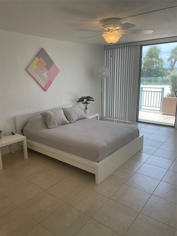1 Key Capri, Unit 104W Treasure Island, FL 33706 - Photo 19 of 49 a bedroom with a bed and a large window