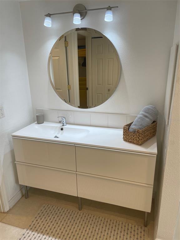 1 Key Capri, Unit 104W Treasure Island, FL 33706 - Photo 21 of 49 a bathroom with a sink and mirror