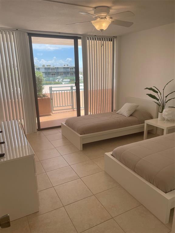 1 Key Capri, Unit 104W Treasure Island, FL 33706 - Photo 27 of 49 a bedroom with furniture and a large window