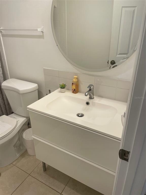 1 Key Capri, Unit 104W Treasure Island, FL 33706 - Photo 29 of 49 a bathroom with a sink and a toilet