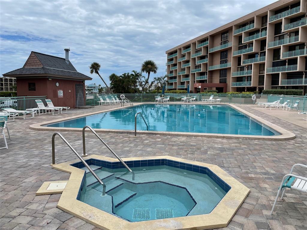 1 Key Capri, Unit 104W Treasure Island, FL 33706 - Photo 3 of 49 a view of a swimming pool with a lounge chairs