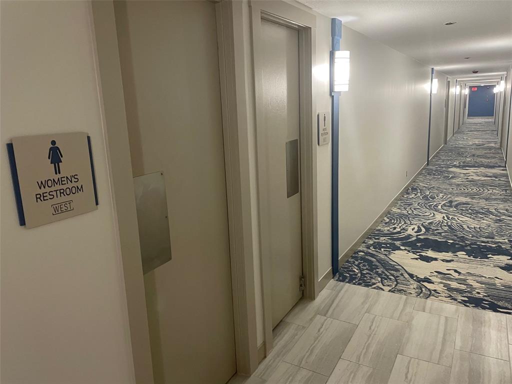 1 Key Capri, Unit 104W Treasure Island, FL 33706 - Photo 32 of 49 a view of a hallway with wooden floor