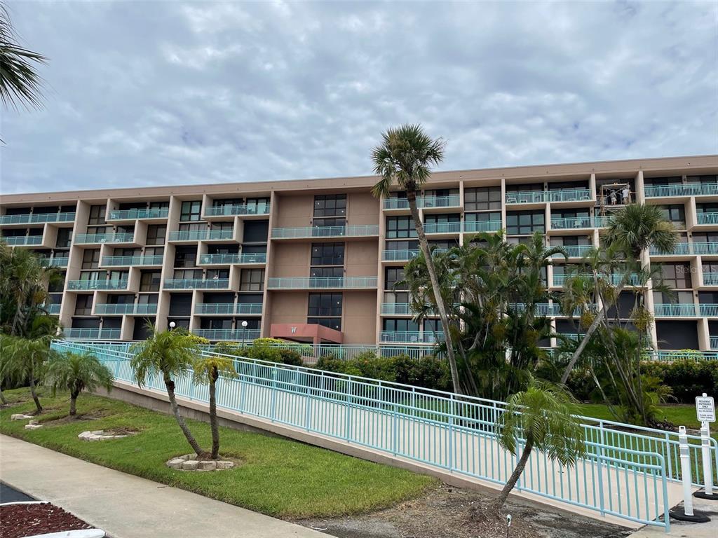 1 Key Capri, Unit 104W Treasure Island, FL 33706 - Photo 36 of 49 a house view with a garden space