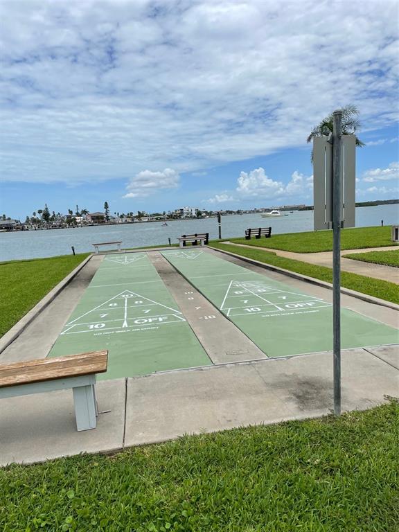 1 Key Capri, Unit 104W Treasure Island, FL 33706 - Photo 45 of 49 a view of a swimming pool with a yard