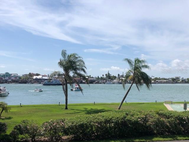 1 Key Capri, Unit 104W Treasure Island, FL 33706 - Photo 46 of 49 a view of a garden with a lake