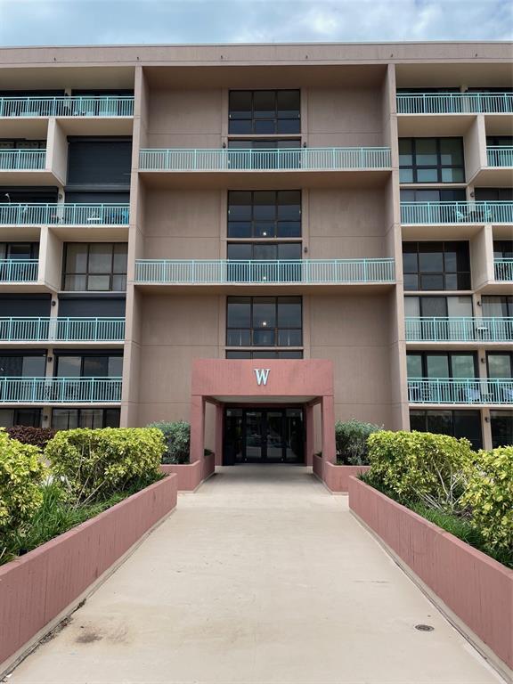 1 Key Capri, Unit 104W Treasure Island, FL 33706 - Photo 5 of 49 a front view of a house with a garden