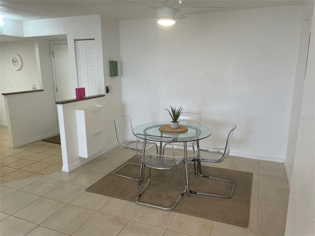 1 Key Capri, Unit 104W Treasure Island, FL 33706 - Photo 10 of 49 a dining room with furniture and a window