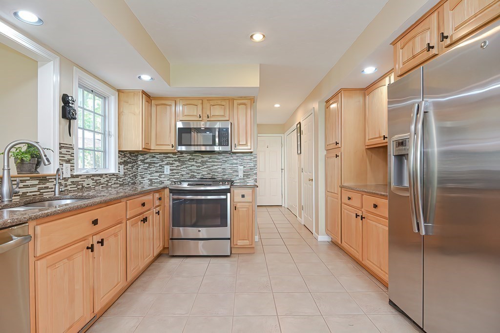 38 Pennock Road Ashland, MA 01721 - Photo 11 of 40 a kitchen with stainless steel appliances granite countertop a refrigerator and a sink