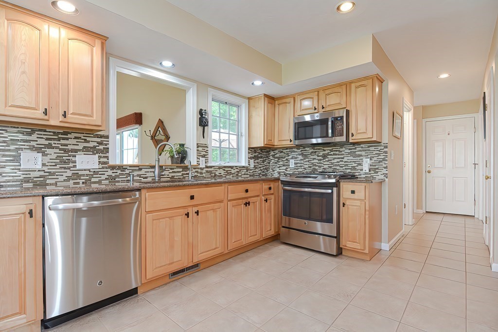 38 Pennock Road Ashland, MA 01721 - Photo 12 of 40 a kitchen with granite countertop white cabinets white stainless steel appliances with a sink and dishwasher