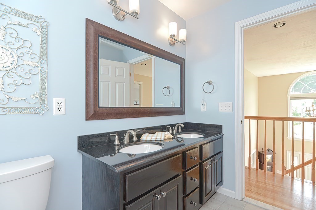 38 Pennock Road Ashland, MA 01721 - Photo 26 of 40 a bathroom with a granite countertop sink and a mirror