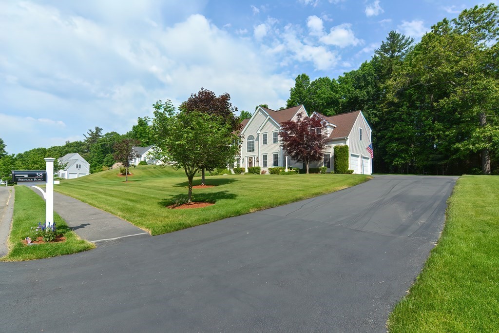 38 Pennock Road Ashland, MA 01721 - Photo 3 of 40 a front view of a house with a yard and garage