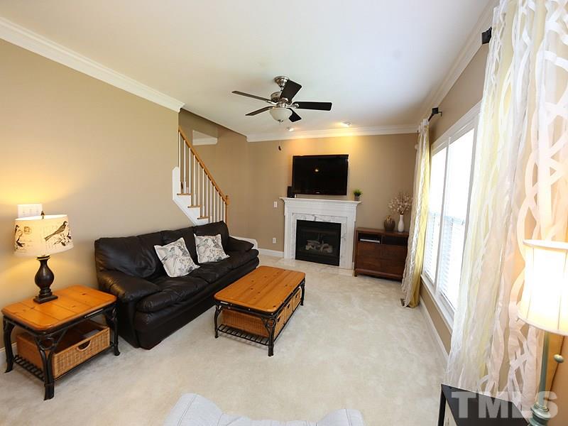 2008 Waterbrook Court Raleigh, NC 27603 - Photo 4 of 13 a living room with furniture flat screen tv and a fireplace