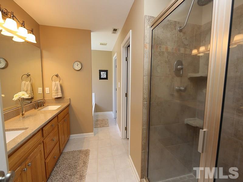 2008 Waterbrook Court Raleigh, NC 27603 - Photo 9 of 13 a bathroom with a granite countertop shower mirror and a sink