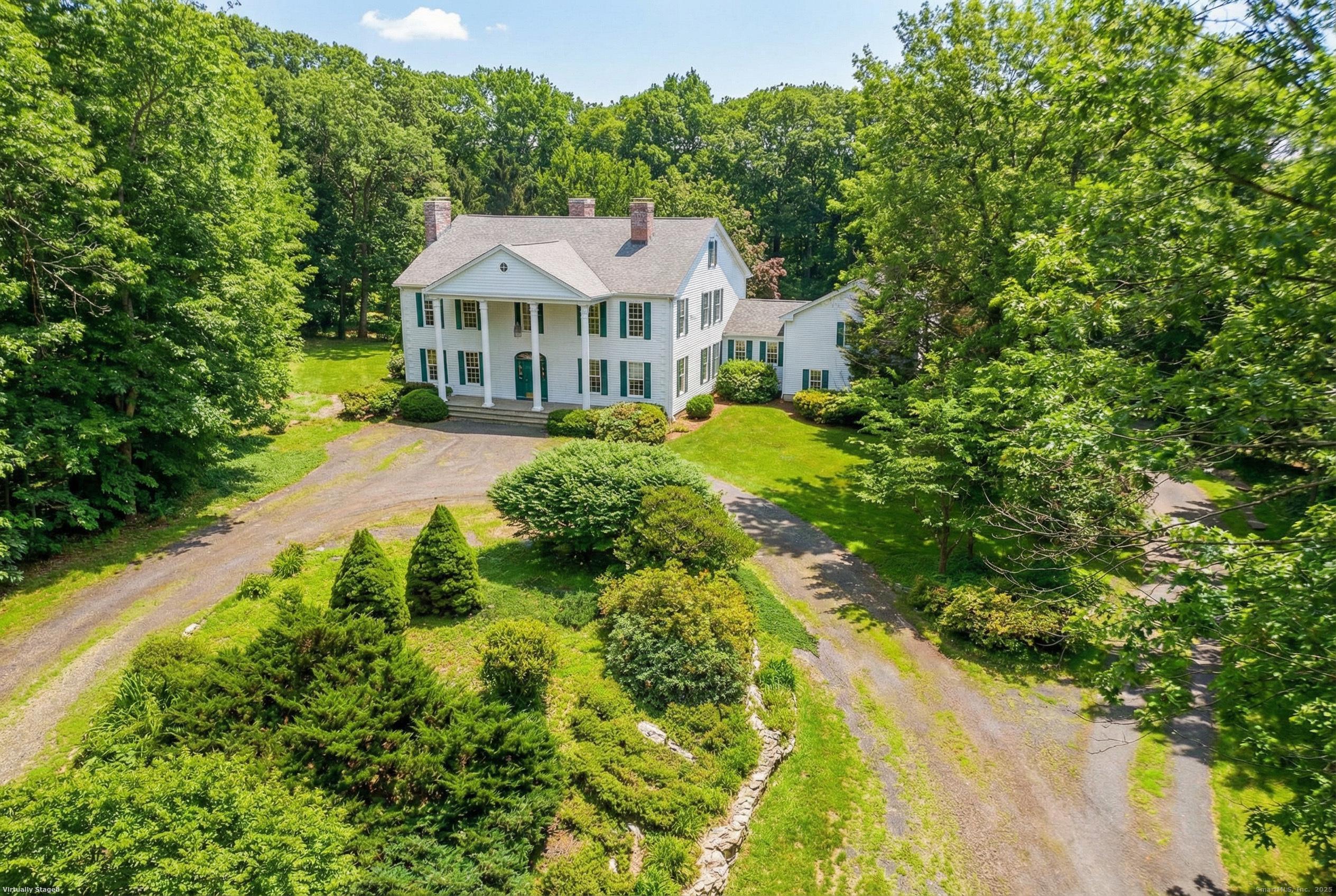 a view of a house with a yard and potted plants