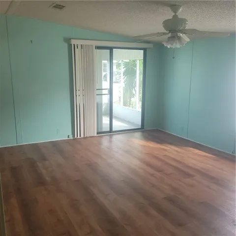 en empty room with windows and fan