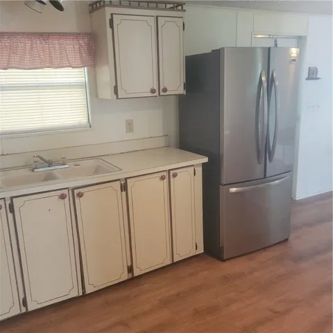 a kitchen with cabinets and stainless steel appliances
