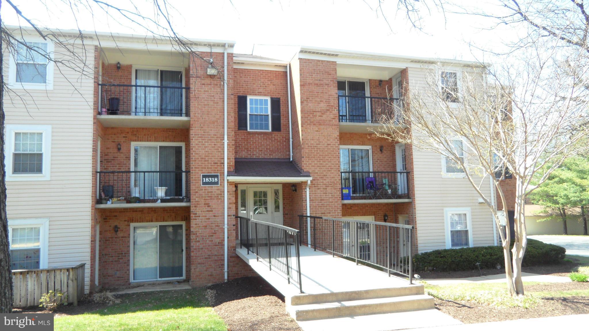 18318 Streamside Drive, Unit 304 Gaithersburg, MD 20879 - Photo 2 of 30 a view of a building with a yard
