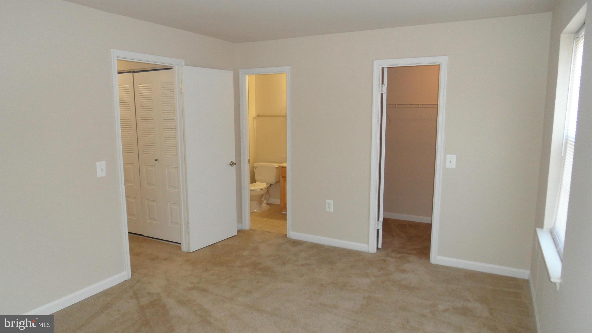 18318 Streamside Drive, Unit 304 Gaithersburg, MD 20879 - Photo 12 of 30 an empty room with closet and a bathroom