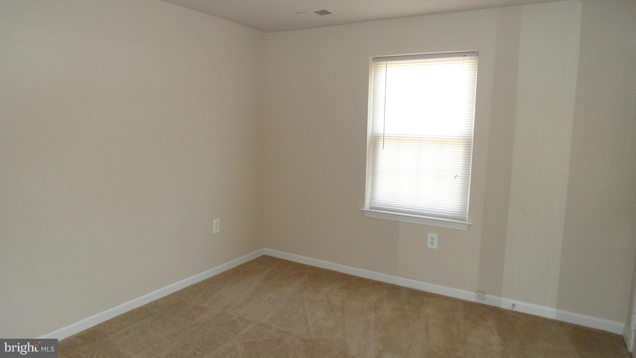 18318 Streamside Drive, Unit 304 Gaithersburg, MD 20879 - Photo 15 of 30 an empty room with a window