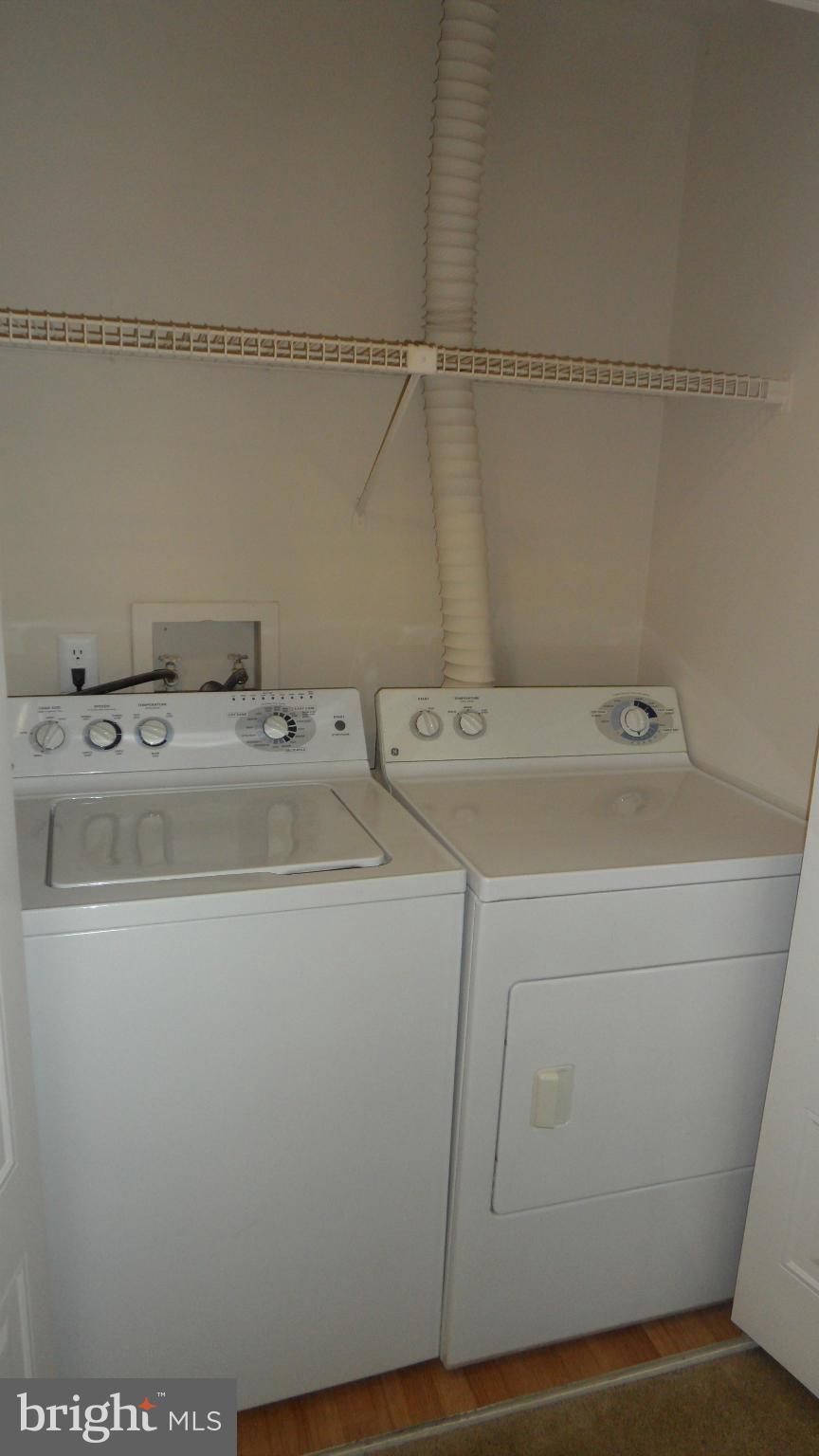 18318 Streamside Drive, Unit 304 Gaithersburg, MD 20879 - Photo 18 of 30 a utility room with dryer and washer
