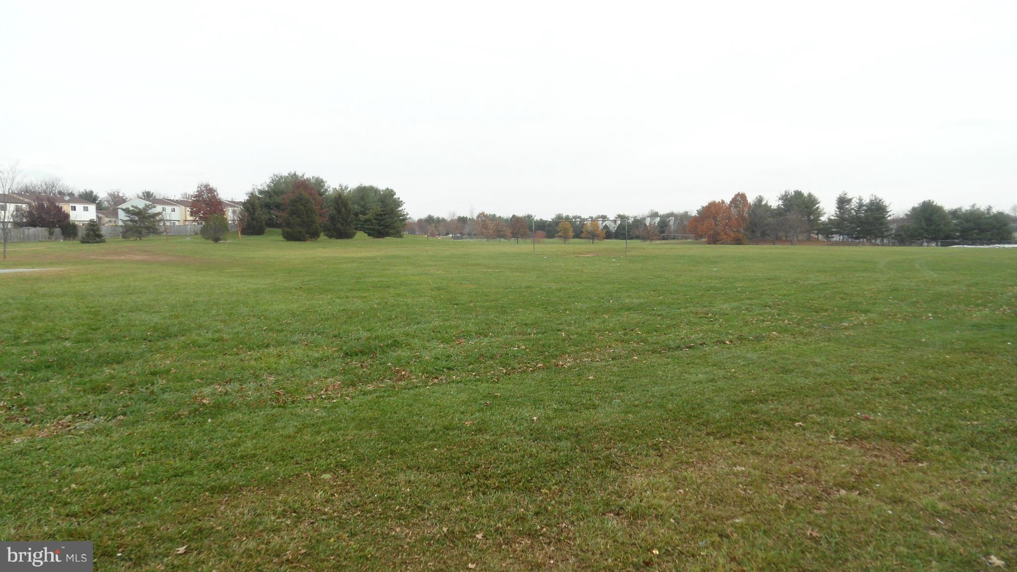 18318 Streamside Drive, Unit 304 Gaithersburg, MD 20879 - Photo 28 of 30 a view of a green field with trees