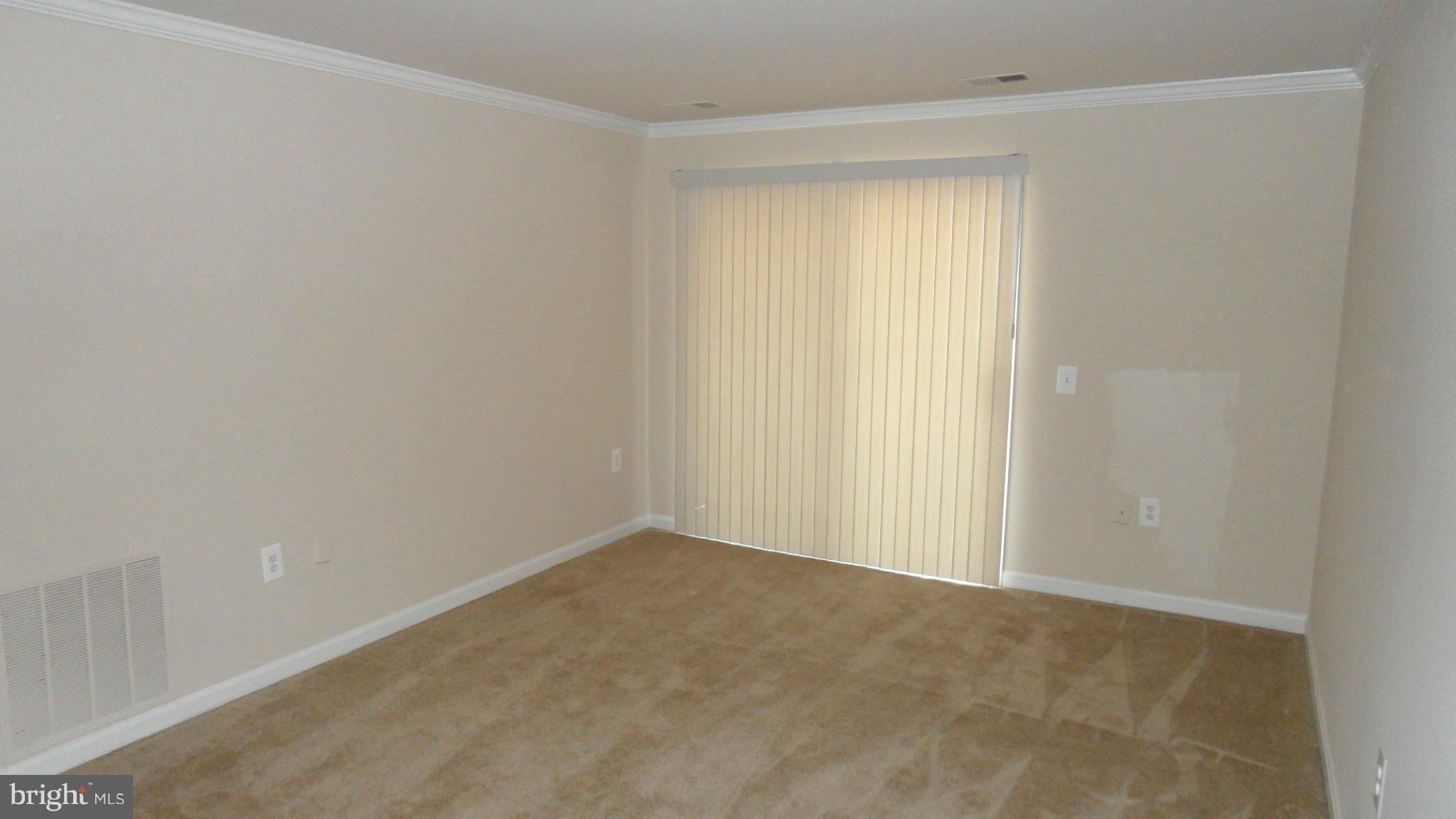 18318 Streamside Drive, Unit 304 Gaithersburg, MD 20879 - Photo 4 of 30 a view of an empty room with a window