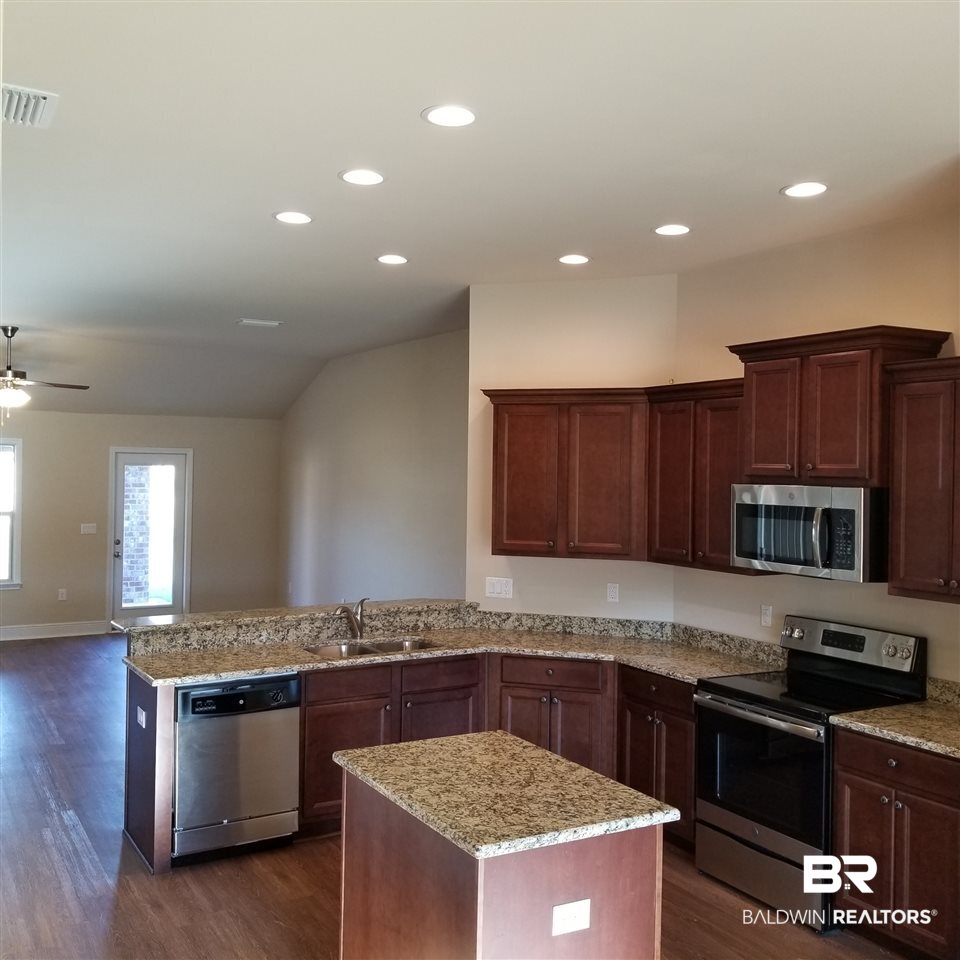 14606 Troon Drive Foley, AL 36535 - Photo 9 of 18 Island with granite top and power outet