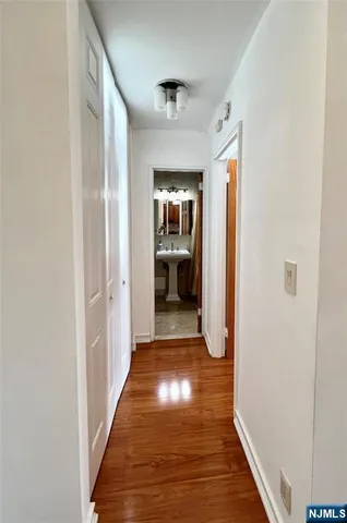 a view of a hallway view with wooden floor and staircase
