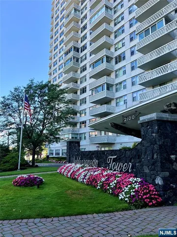a front view of building with garden