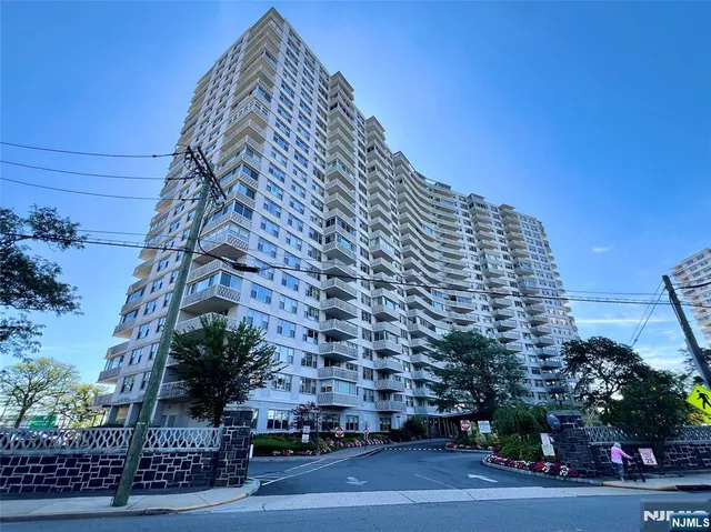 a view of a tall building next to a road