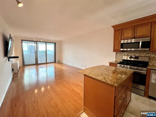 a kitchen with a stove a sink and a microwave