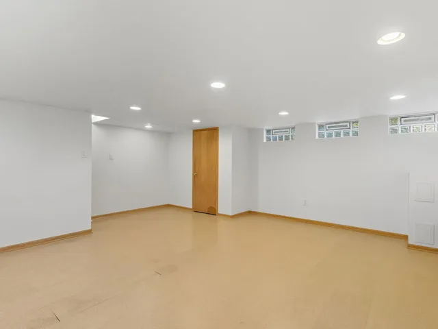 an empty room with a projector and entrance
