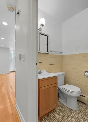 a bathroom with a sink toilet and mirror