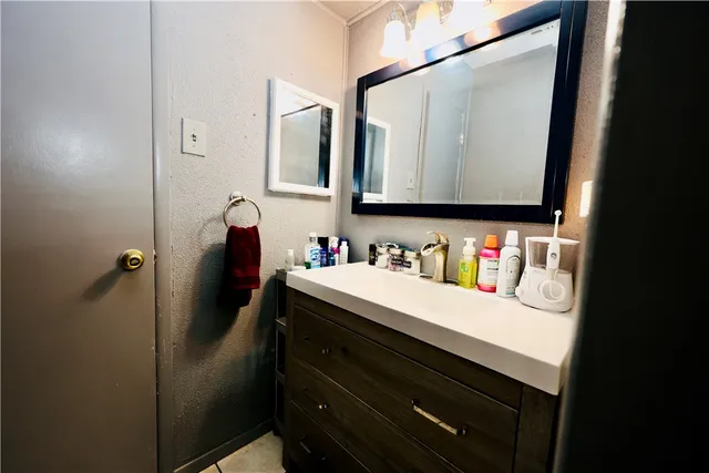 a bathroom with a sink vanity and a mirror