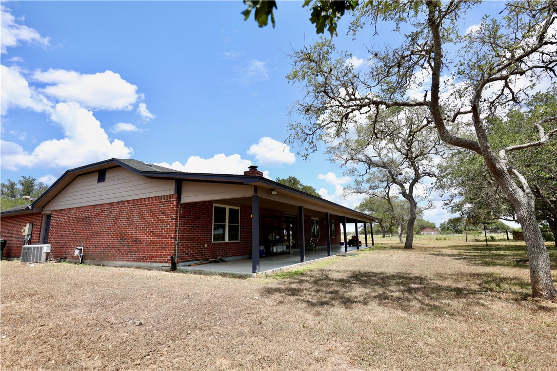 903 McGuill Road Goliad, TX 77963 - Photo 16 of 17 a view of a house with a yard and garage