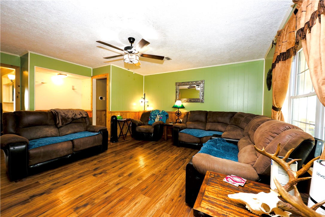 903 McGuill Road Goliad, TX 77963 - Photo 2 of 17 a living room with furniture a ceiling fan and a window