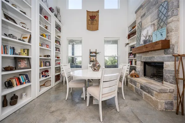 a dining room with a bookshelf and a fireplace