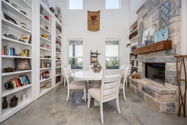 a dining room with a bookshelf and a fireplace