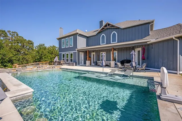 a front view of a house with swimming pool yard and patio