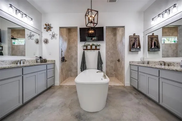 a bathroom with a sink a mirror a bathtub and shower