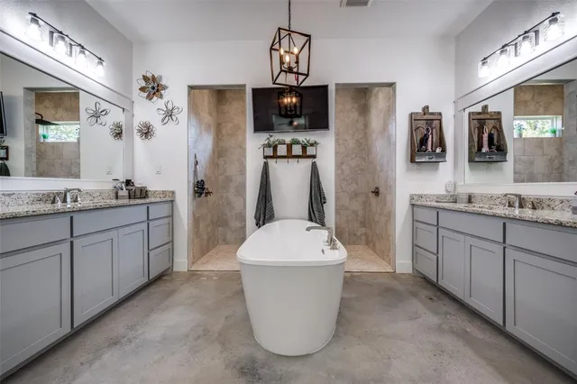 a bathroom with a sink a mirror a bathtub and shower