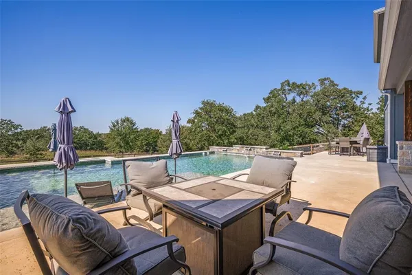 a view of a patio with a table and chairs