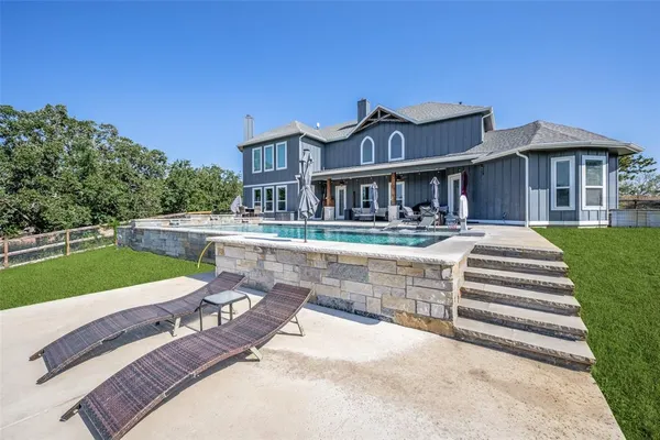 a view of a house with a yard porch and sitting area