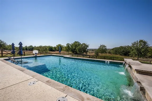 a view of a lake with boats and trees in the background