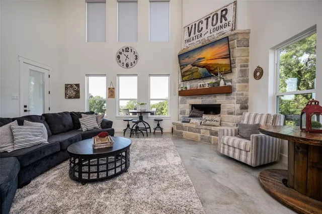a living room with furniture fireplace and window