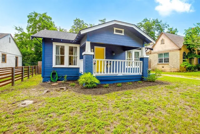 a front view of a house with a garden and porch