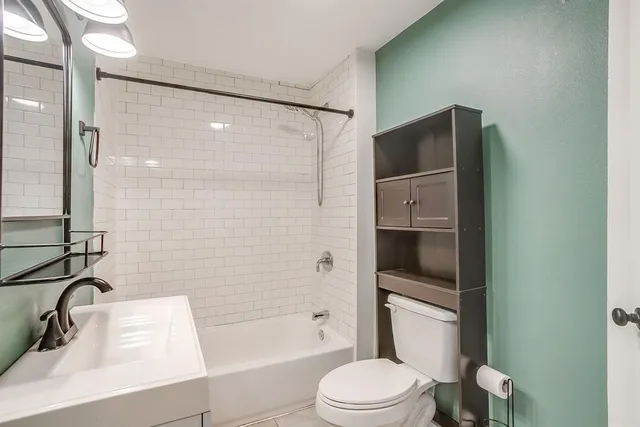 a bathroom with a sink toilet and shower